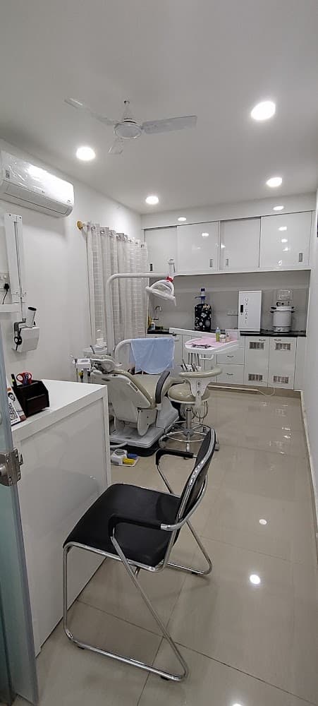Dr. Pallavi's Dental Care operatory: a spotless white treatment room with a beige dental chair, white cabinets and a sterilisation unit